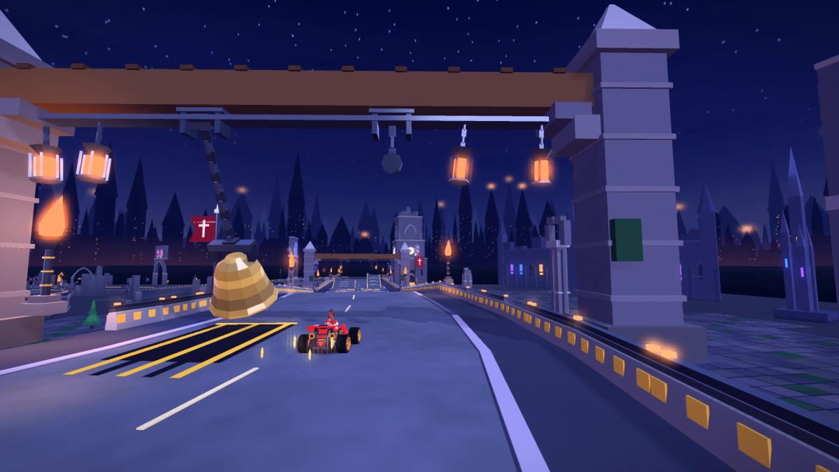 A red kart approaching a large golden bell suspended over the road between stone towers and firelit arches.