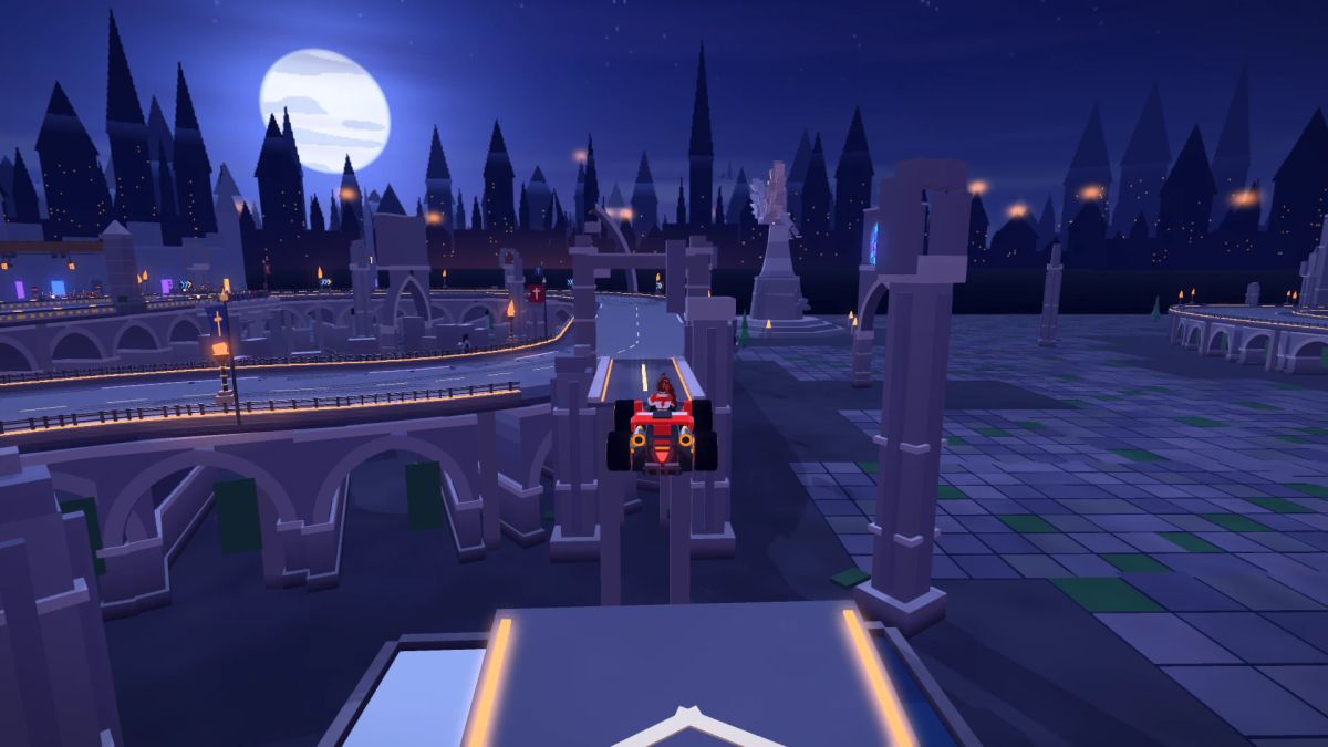 A red kart airborne over a break in the elevated stone gallery, with the cathedral ruins and full moon beyond.