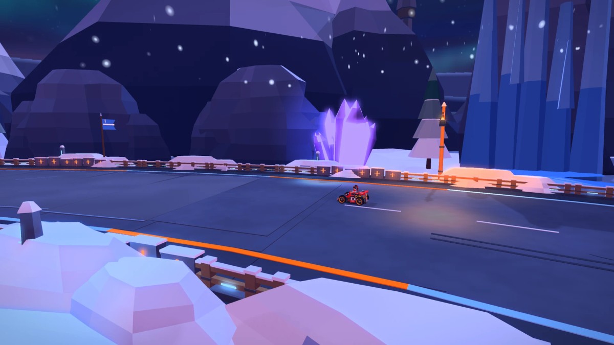 A red kart rounding Frozen Fang beneath a tall frozen waterfall, with snow-covered rocks and blue crystals beside the road.