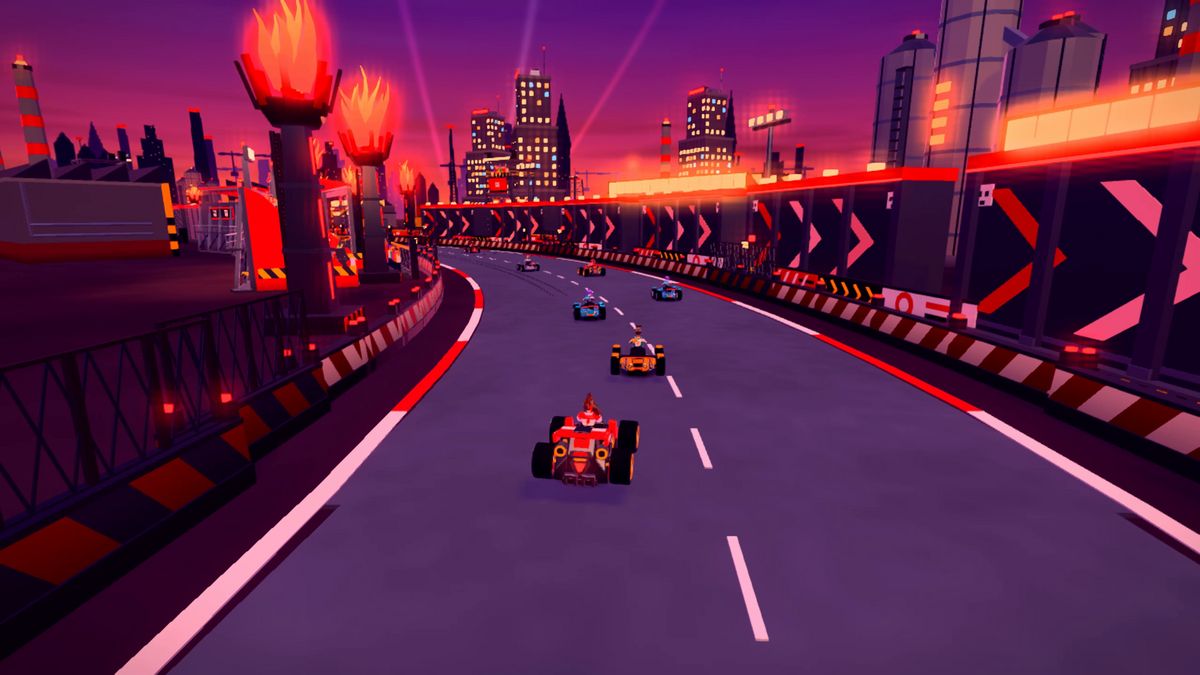 A pack of karts following the Outer Ring’s long curve beside the arrow-covered driftwall and flame towers.